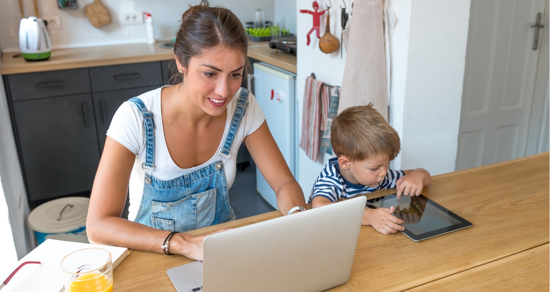 Mom working from home with kid working on ipad