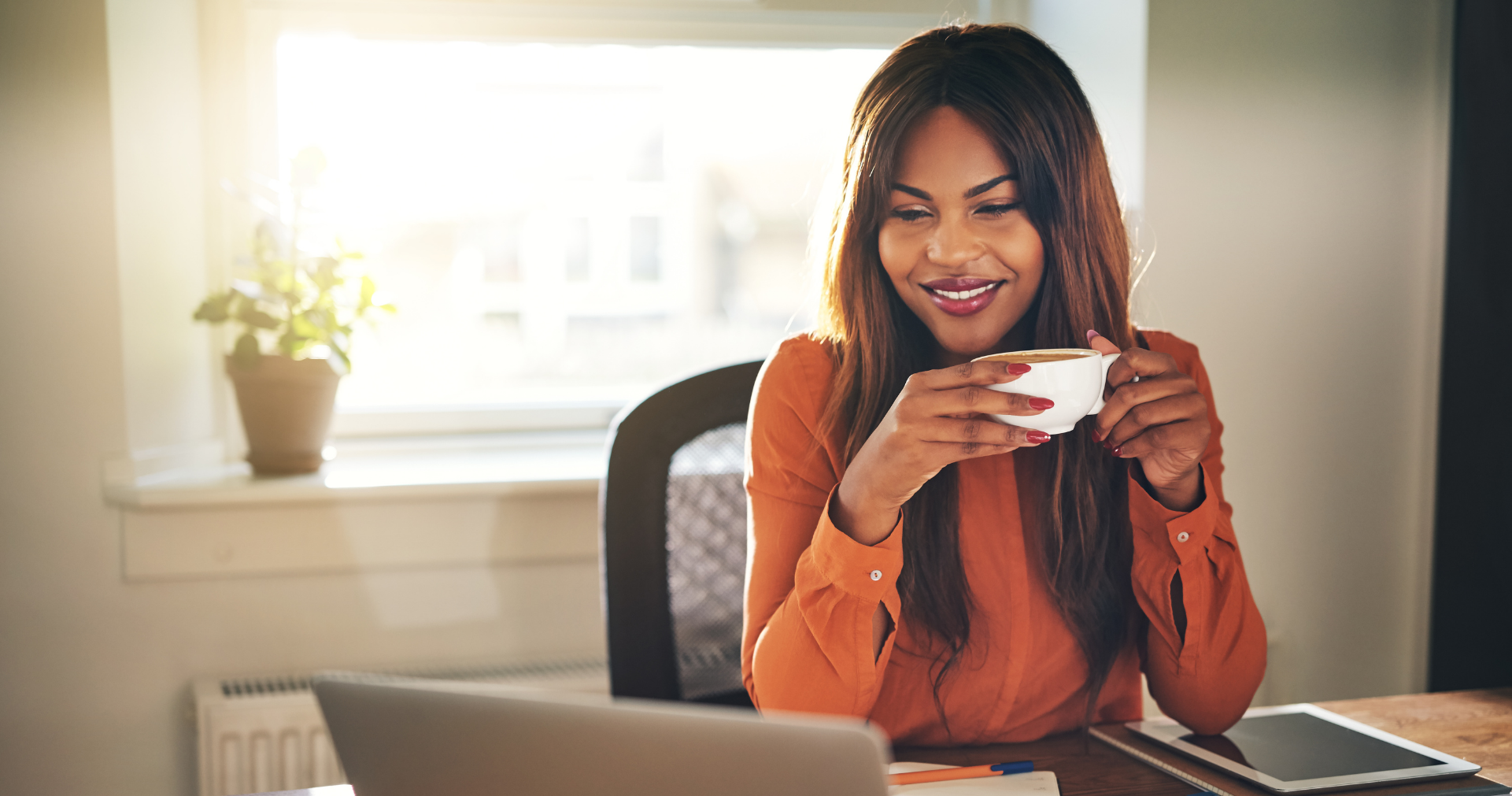 Woman with Coffee Working on Laptop